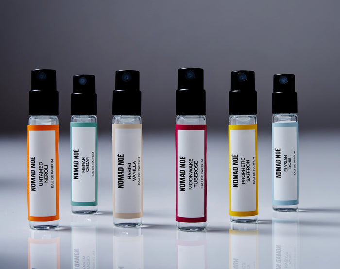 Six Eau de Parfum sample vials from the Nomad Noé Discovery Set lined up