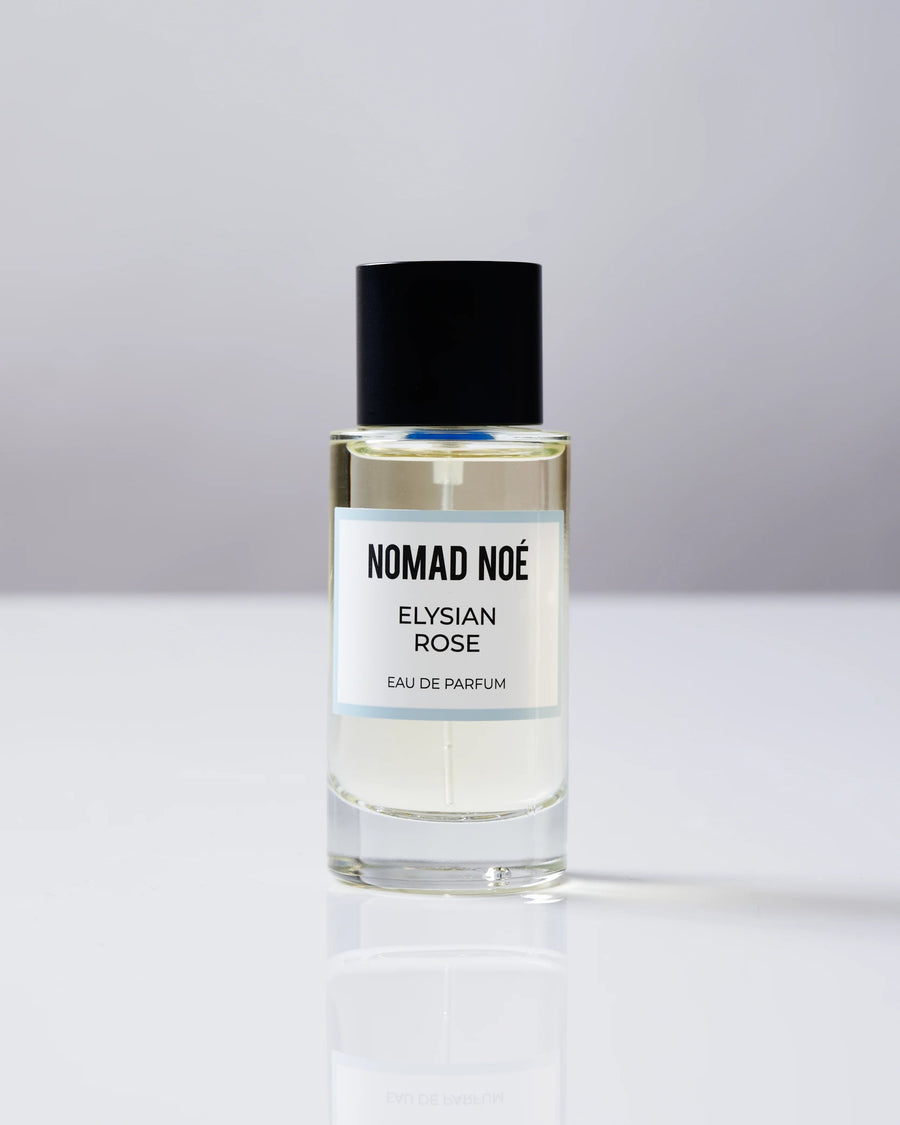 ELYSIAN ROSE Eau de Parfum bottle by Nomad Noé with black cap on a white surface